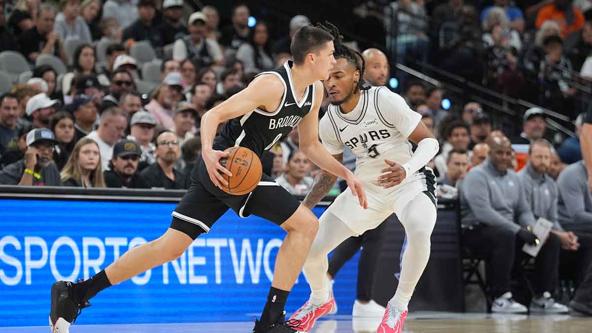 Brooklyn Nets guard Egor Demin (8) dribbles against San Antonio Spurs guard Stephon Castle (5) in the first half at Frost Bank Center.