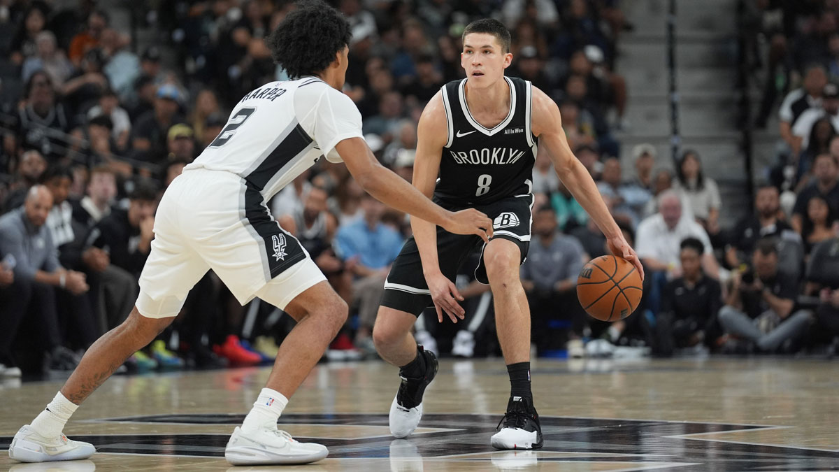 Brooklyn Nets guard Egor Demin (8) dribbles against San Antonio Spurs guard Dylan Harper (2) in the second half at Frost Bank Center.