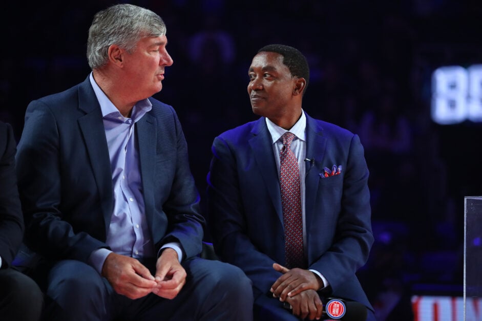 Former Detroit Piston Isiah Thomas talks to teammate Bill Laimbeer during a celebration of the 1989 and 1990 World Championship Detroit Pistons at halftime during a game between the Portland Trail Blazers and Detroit Pistons at Little Caesars Arena.