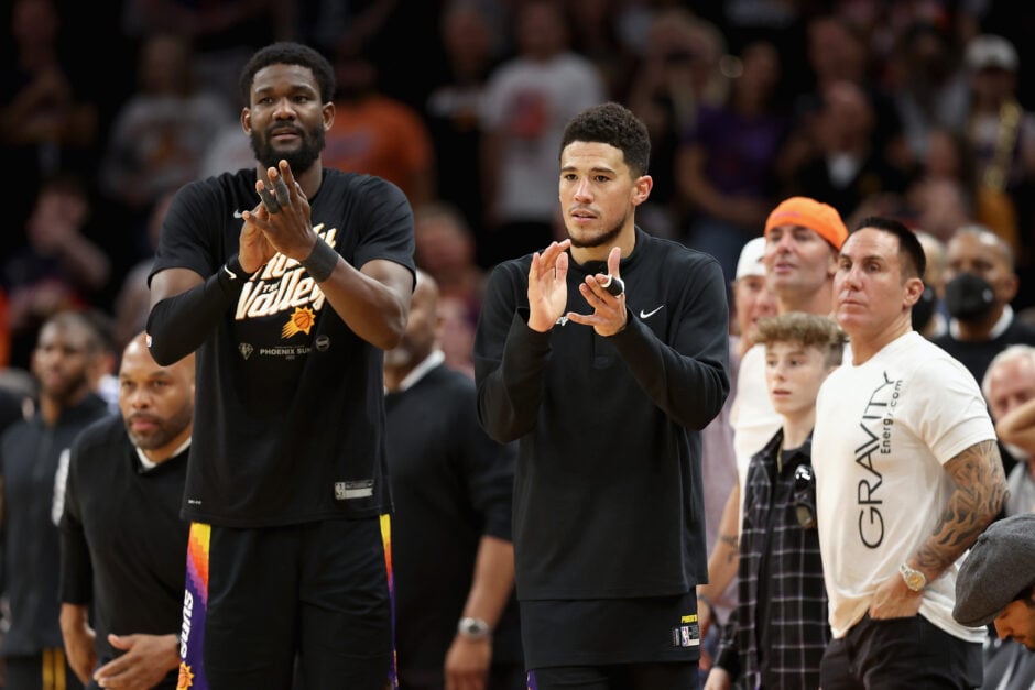Deandre Ayton #22 and Devin Booker #1 of the Phoenix Suns cheer from the bench during the second half of Game Five of the Western Conference Second Round NBA Playoffs at Footprint Center on May 10, 2022 in Phoenix, Arizona. The Suns defeated the Mavericks 110-80.