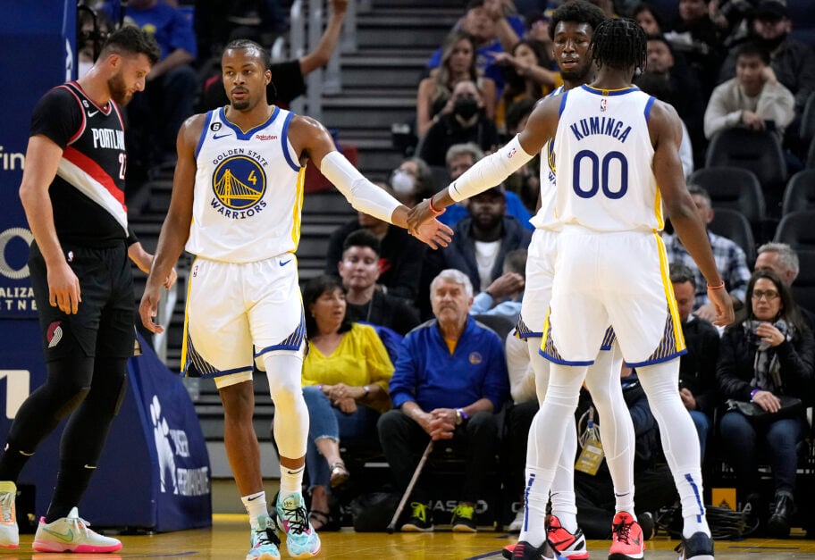 Moses Moody #4 of the Golden State Warriors is congratulated by Jonathan Kuminga #00 after Moody scored and was fouled on the shot against the Portland Trail Blazers during the first quarter of an NBA basketball game at Chase Center on October 11, 2022 in San Francisco, California.