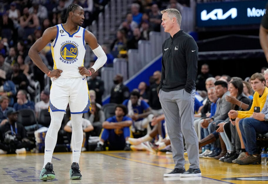 Head coach Steve Kerr and Jonathan Kuminga #00 of the Golden State Warriors talk with each other during a break in the action against the Denver Nuggets in the second half of an NBA basketball game at Chase Center.