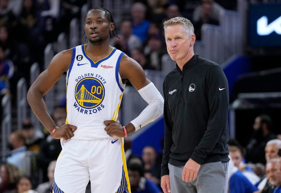 Head coach Steve Kerr and Jonathan Kuminga #00 of the Golden State Warriors talk with each other during a break in the action against the Denver Nuggets in the second half of an NBA basketball game at Chase Center.