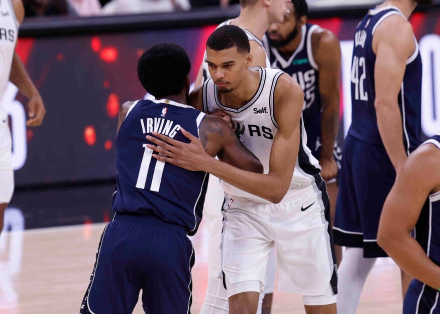 Kyrie Irving and Victor Wembanyama embrace on the court