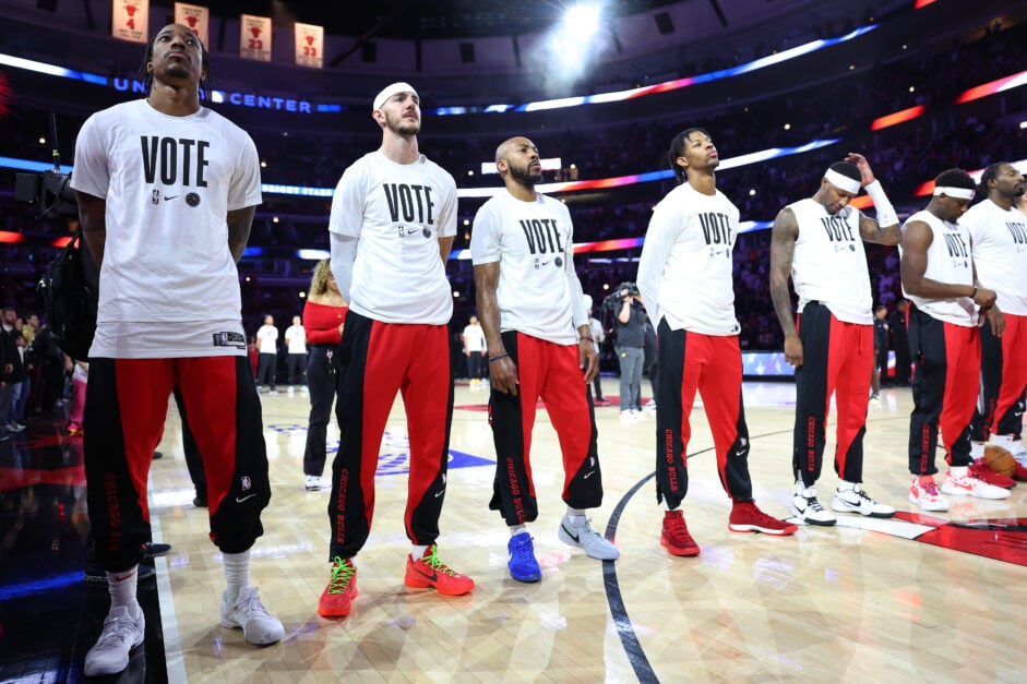 DeMar DeRozan #11, Alex Caruso #6, Jevon Carter #5, Dalen Terry #25, and Torrey Craig #13 of the Chicago Bulls observe the playing of the national anthem prior to the game against the Utah Jazz at the United Center on November 06, 2023 in Chicago, Illinois.