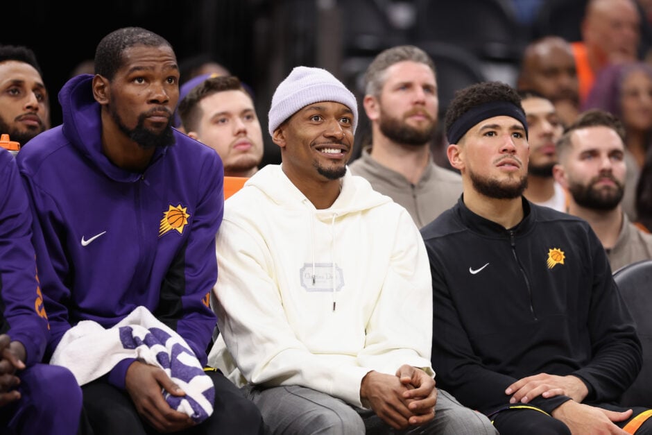 Kevin Durant #35, Bradley Beal #3 and Devin Booker #1 of the Phoenix Suns watch from the bench during the second half of the NBA game against the Minnesota Timberwolves.