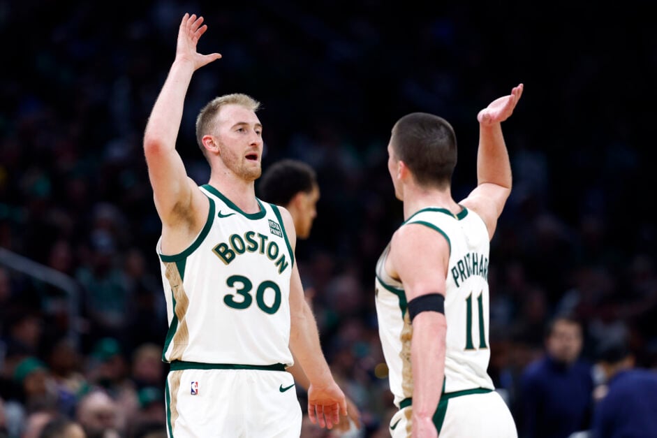 Boston Celtics forward Sam Hauser and guard Payton Pritchard high-five during a timeout in the third quarter.