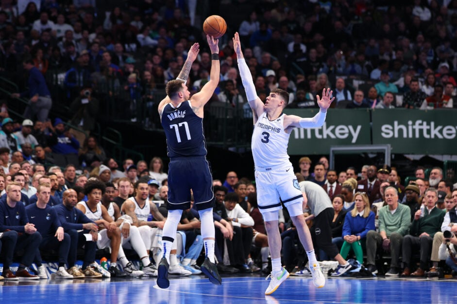 Luka Doncic #77 of the Dallas Mavericks shoots over Jake LaRavia #3 of the Memphis Grizzlies during the first half of an Emirates NBA Cup game at American Airlines Center on December 03, 2024 in Dallas, Texas.
