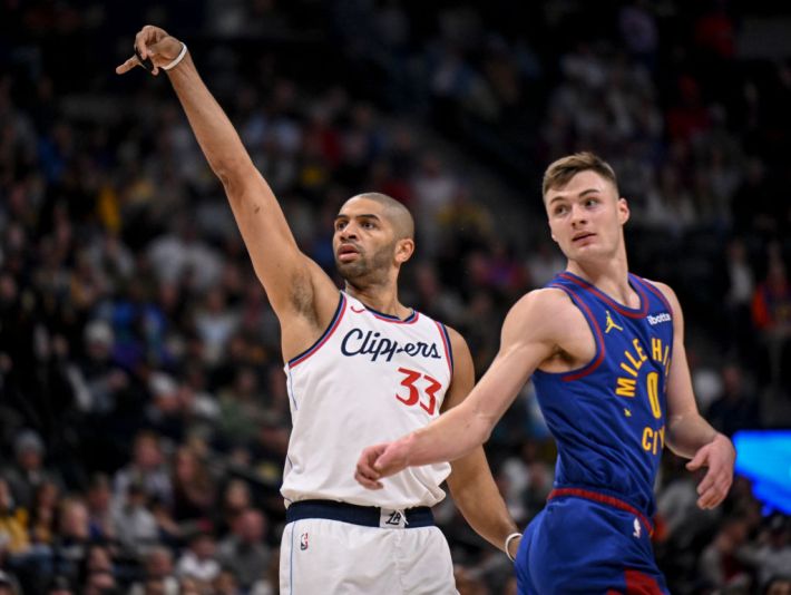 Nicolas Batum (33) of the LA Clippers makes a three pointer as Christian Braun (0) of the Denver Nuggets watches it go in during the first quarter at Ball Arena in Denver, Colorado on Wednesday, January 8, 2025.