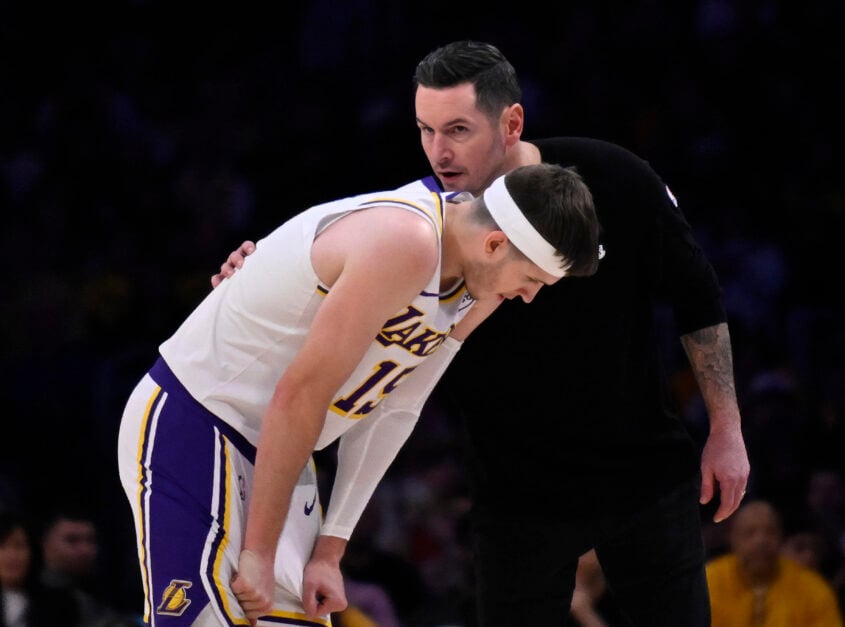 Head coach JJ Redick of the Los Angeles Lakers speaks with Austin Reaves #15 of the Los Angeles Lakers against the Indiana Pacers.