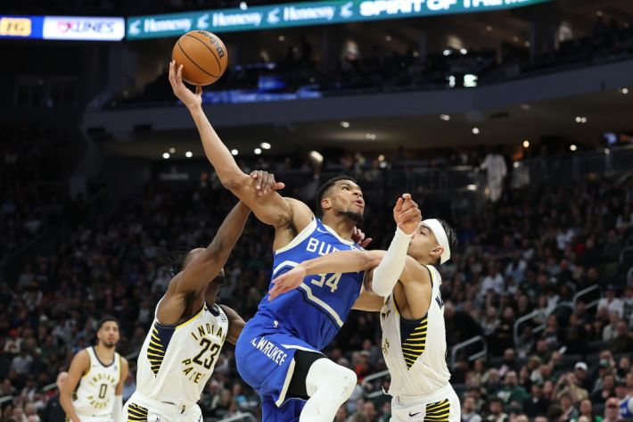 Aaron Nesmith #23 of the Indiana Pacers fouls Giannis Antetokounmpo #34 of the Milwaukee Bucks during the second half of a game at Fiserv Forum on March 15, 2025 in Milwaukee, Wisconsin.