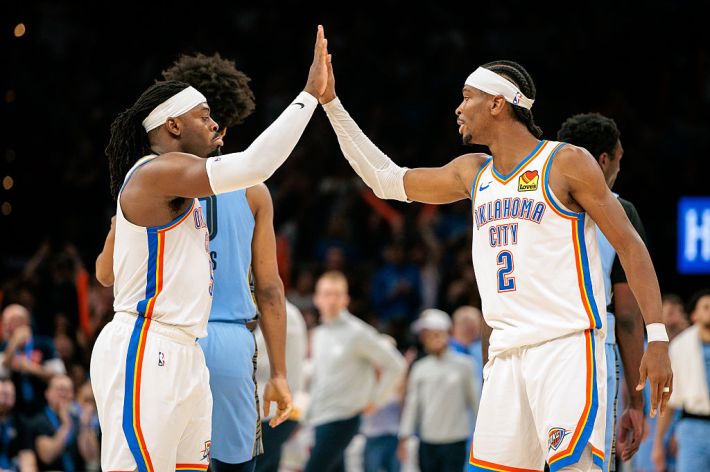 Luguentz Dort #5 of the Oklahoma City Thunder and Shai Gilgeous-Alexander #2 of the Oklahoma City Thunder slap hands after a play during the fourth quarter against the Memphis Grizzlies at Paycom Center on March 27, 2025 in Oklahoma City, Oklahoma.