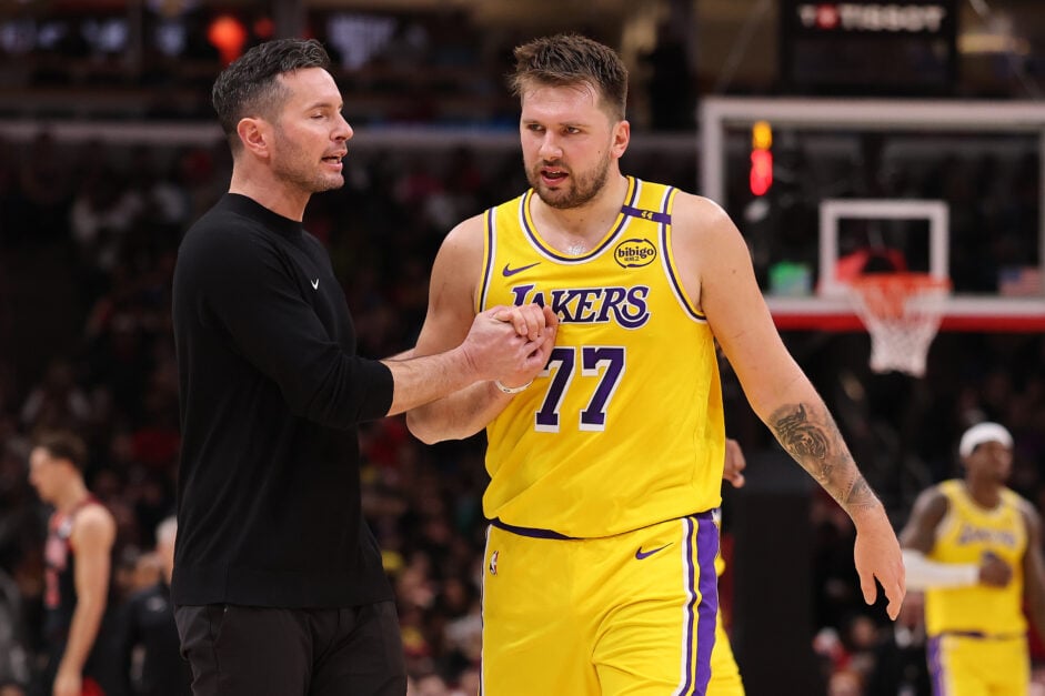 Head coach JJ Redick of the Los Angeles Lakers high fives Luka Doncic #77 against the Chicago Bulls during the second half at the United Center.