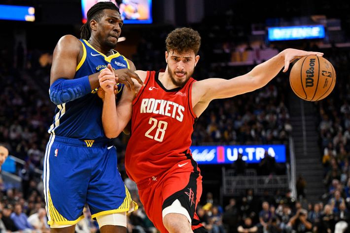 Alperen Sengun #28 of the Houston Rockets dribbles against Kevon Looney #5 of the Golden State Warriors in the third quarter at Chase Center on April 06, 2025 in San Francisco, California. NOTE TO USER: User expressly acknowledges and agrees that, by downloading and or using this photograph, User is consenting to the terms and conditions of the Getty Images License Agreement.