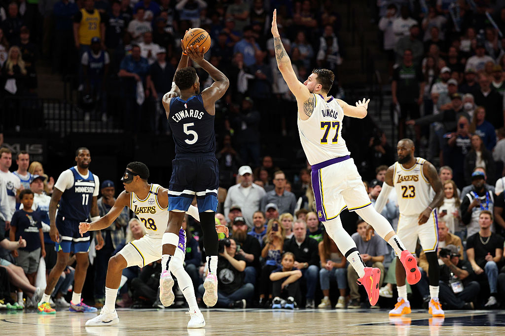 MINNEAPOLIS, MINNESOTA - APRIL 27: Anthony Edwards #5 of the Minnesota Timberwolves shoots the ball against Luka Doncic #77 of the Los Angeles Lakers in the fourth quarter of Game Four of the First Round of the 2025 NBA Playoffs at Target Center on April 27, 2025 in Minneapolis, Minnesota. The Timberwolves defeated the Lakers 116-113 to take a 3-1 series lead. NOTE TO USER: User expressly acknowledges and agrees that, by downloading and or using this photograph, User is consenting to the terms and conditions of the Getty Images License Agreement. (Photo by David Berding/Getty Images)
