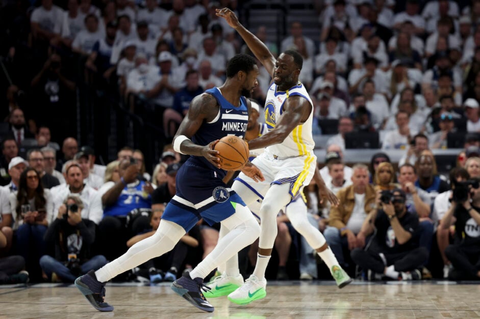 Julius Randle #30 of the Minnesota Timberwolves dribbles against Draymond Green #23 of the Golden State Warriors during the first quarter of Game Five of the Western Conference Second Round NBA Playoffs at Target Center.