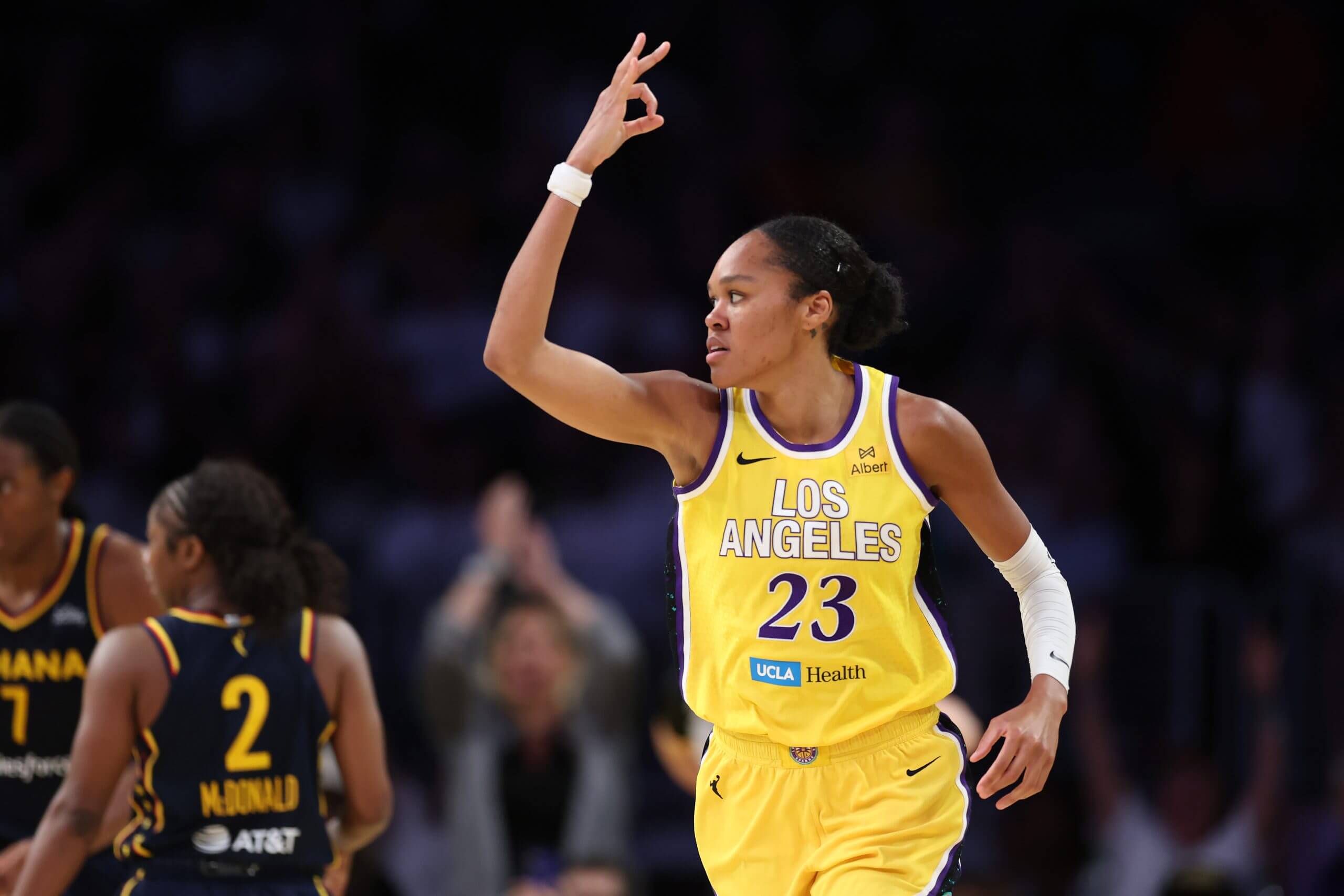 Azurá Stevens signals three fingers after making a 3-pointer against the Indiana Fever.
