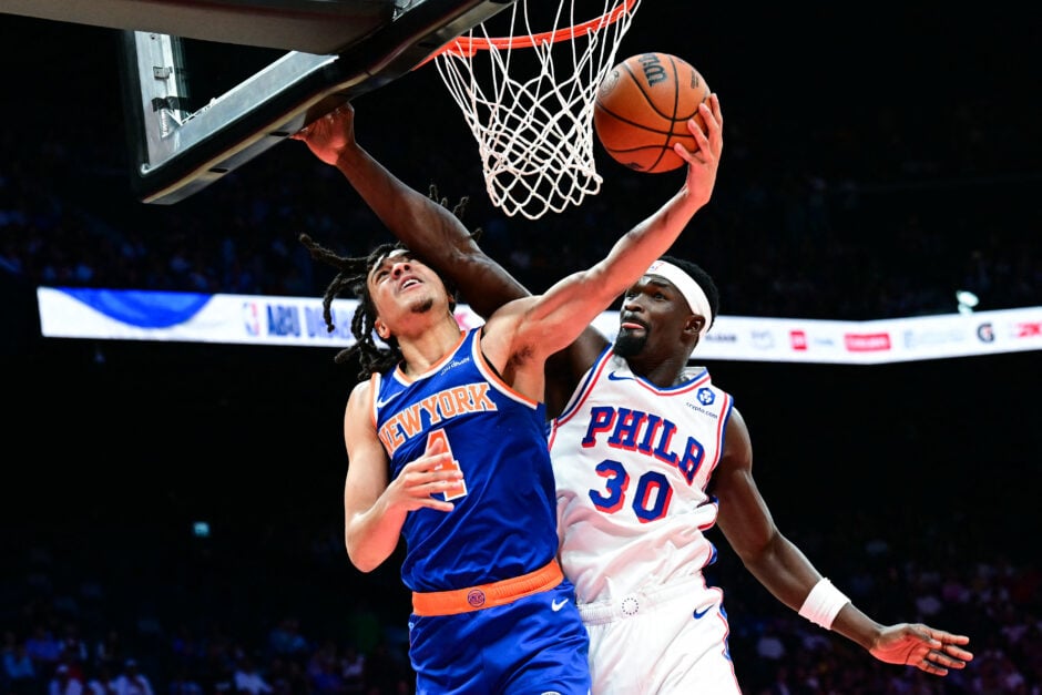 New York Knicks' #04 Pacome Dadiet goes to the basket as Philadelphia 76ers' #30 Adem Bona defends