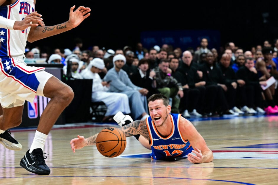 New York Knicks' #14 Garrison Mathews falls on the court as he fights for the ball during the NBA basketball game between the New York Knicks and the Philadelphia 76ers.