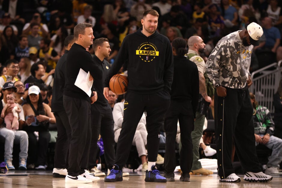 Luka Doncic #77 of the Los Angeles Lakers looks on in street clothes during a timeout