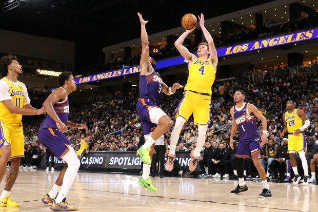 The Lakers’ Dalton Knecht shoots as the Phoenix Suns’ Dillon...