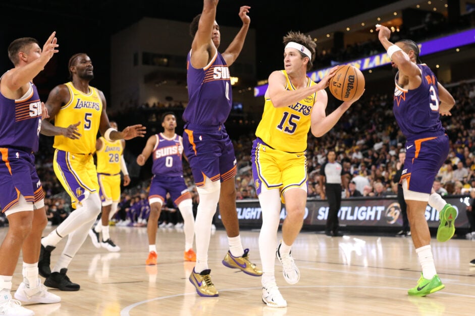 Austin Reaves #15 of the Los Angeles Lakers drives around Jalen Green #4 of the Phoenix Suns during the second half of a game at Acrisure Arena.
