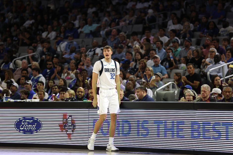 Cooper Flagg #32 of the Dallas Mavericks waits at the scorers table during the first half of a preseason game against the Oklahoma City Thunder at Dickies Arena on October 06, 2025 in Fort Worth, Texas.