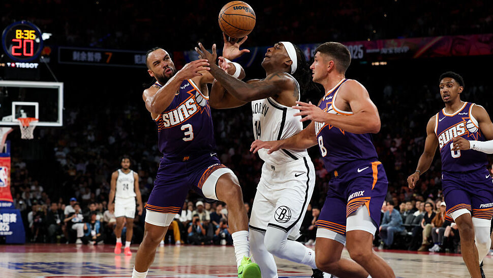 Terance Mann #14 of Brooklyn Nets competes with Dillon Brooks #3 of Phoenix Suns during NBA China G...