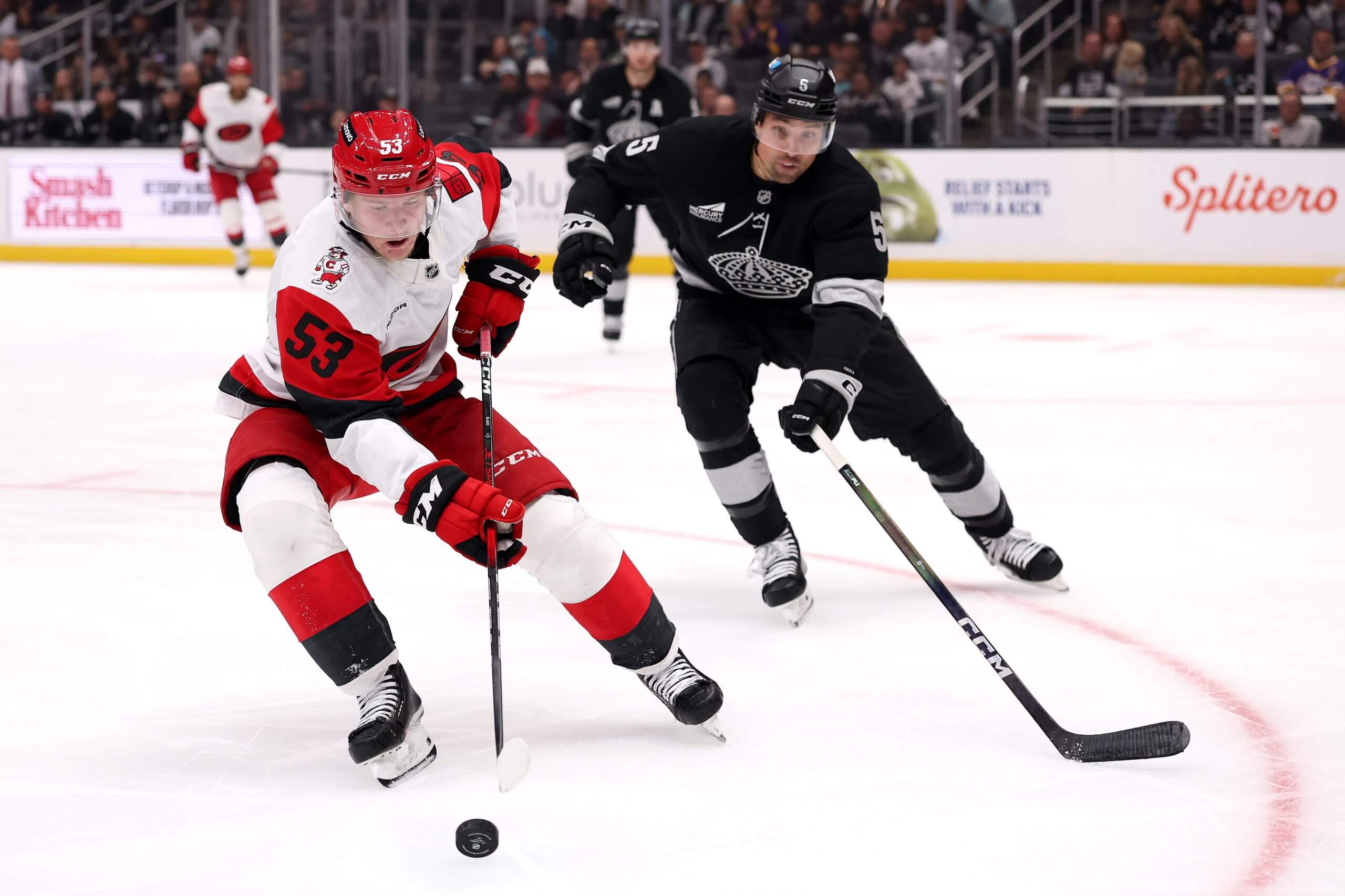 Cody Ceci tries to put pressure on Carolina's Jackson Blake