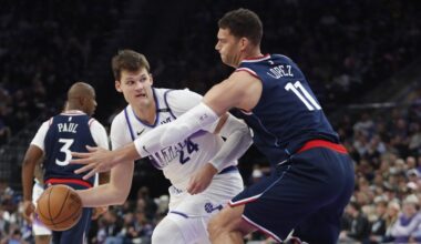 Walker Kessler #24 of the Utah Jazz passes around Brook Lopez #11 of the Los Angeles Clippers...