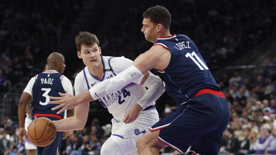 Walker Kessler #24 of the Utah Jazz passes around Brook Lopez #11 of the Los Angeles Clippers...