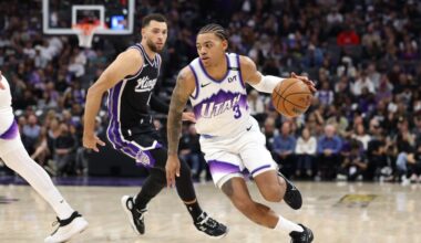 Keyonte George #3 of the Utah Jazz is guarded by Zach Lavine #8 of the Sacramento Kings...