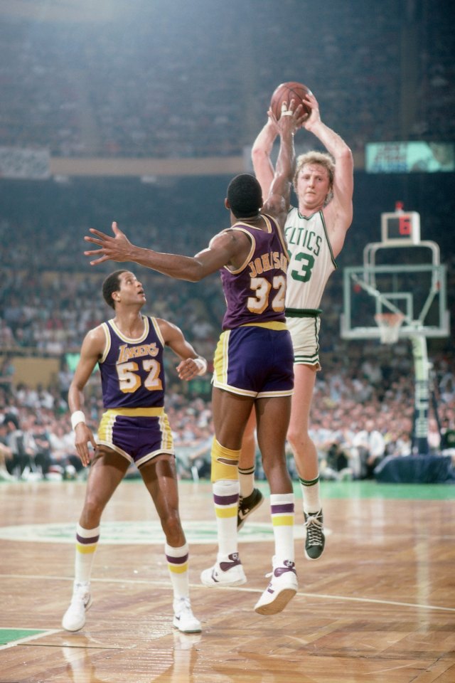 BOSTON - JUNE 8:  Larry Bird #33 of the Boston Celtics passes against Magic Johnson #32 of the Los Angeles Lakers in Game Five of the 1984 NBA Finals played on June 8, 1984 at Boston Garden in Boston, Massachusetts. Boston defeated Los Angeles 121-103. NOTE TO USER: User expressly acknowledges that, by downloading and or using this photograph, User is consenting to the terms and conditions of the Getty Images License agreement. Mandatory Copyright Notice: Copyright 1984 NBAE (Photo by Dick Raphael/NBAE via Getty Images)