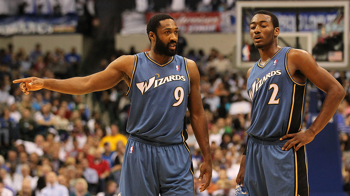 Washington Wizards guard Gilbert Arenas (9) talks with guard John Wall (2) in the second quarter against the Dallas Mavericks at American Airlines Center. 