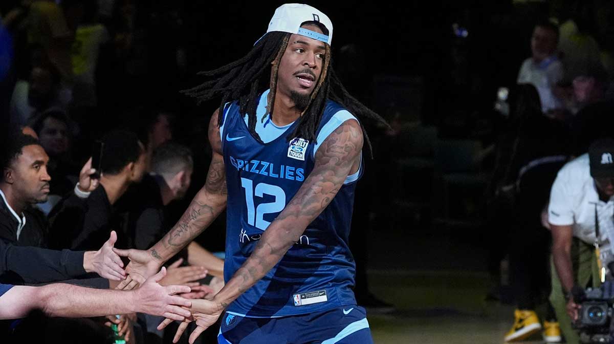 Grizzlies' Ja Morant (12) and Kentavious Caldwell-Pope (3) laugh together during open practice at the FedExForum on October 4, 2025, in Memphis, Tenn. with ESPN's Kendrick Perkins in the background
