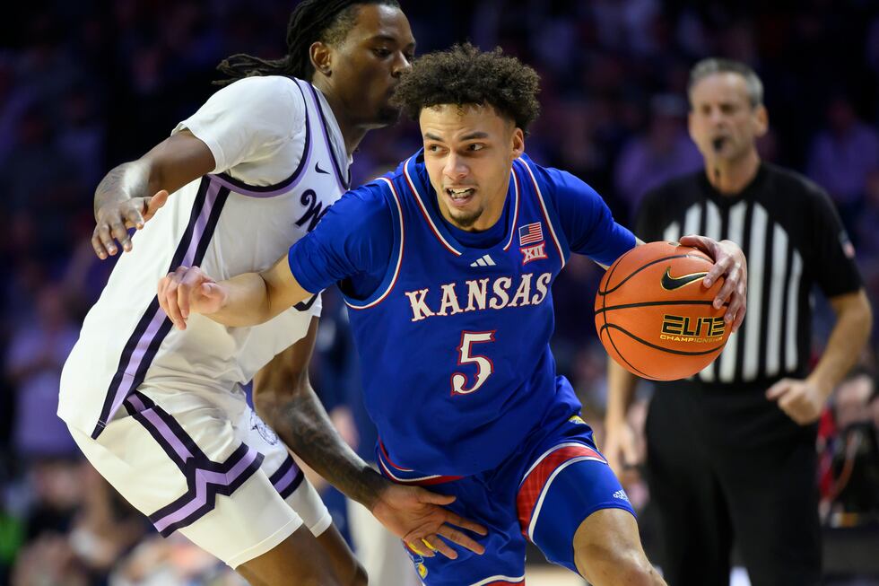 Kansas guard Zeke Mayo (5) drives around Kansas State guard C.J. Jones, left, during the first...