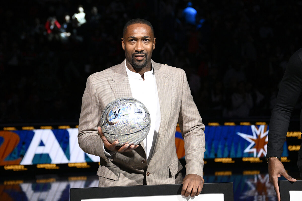 Former Washington Wizards player Gilbert Arenas takes part in a ceremony during the half-time of an NBA basketball game between the Wizards and the Miami Heat, Friday, Nov. 18, 2022, in Washington. (AP Photo/Nick Wass)