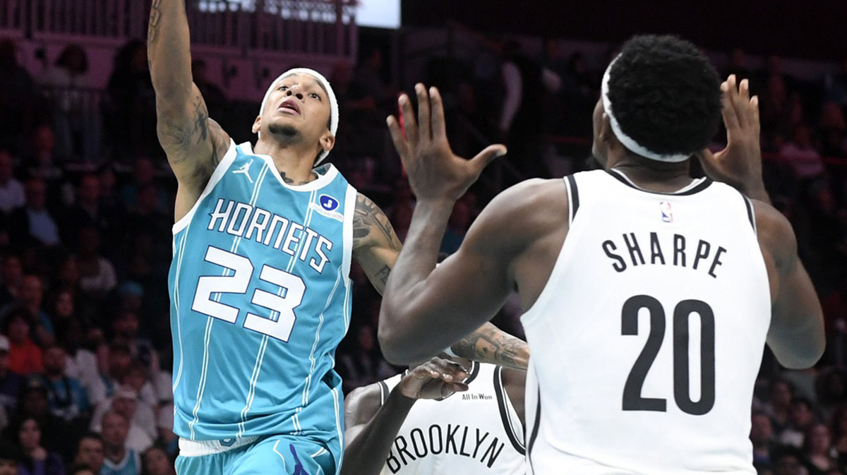 Charlotte Hornets guard Tre Mann (23) drives in as he is defended by Brooklyn Nets center Day’Ron Sharpe (20) during the second half at the Spectrum Center.