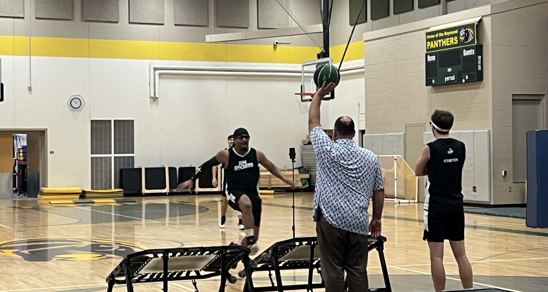 Milwaukee Bucks Rim Rockers visit Raymond School, gym teacher is a member of the squad