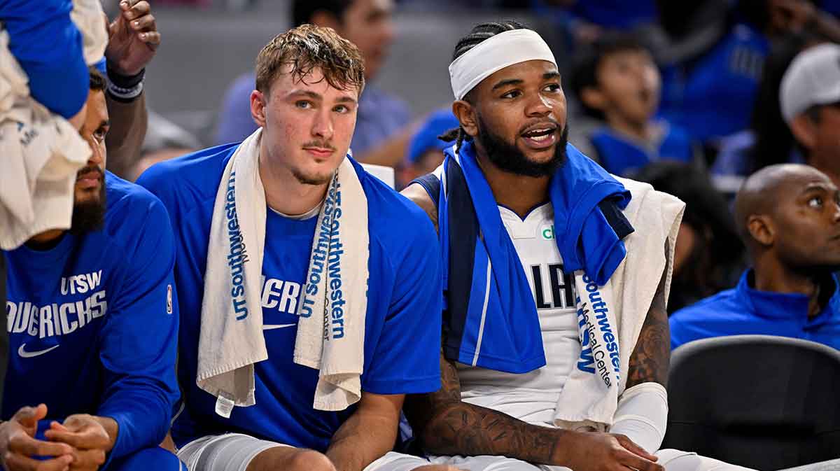 Dallas Mavericks forward Cooper Flagg (left) and guard Jaden Hardy (right) look on during the game between the Dallas Mavericks and the Oklahoma City Thunder at Dickie's Arena.
