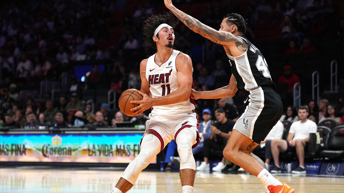 Miami Heat guard Jaime Jaquez Jr. (11) looks to pass the ball as San Antonio Spurs forward Lindy Waters III (43) defends in the first half at Kaseya Center.