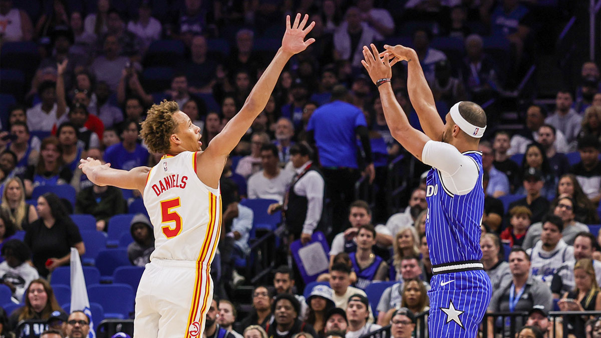 Orlando Magic guard Jalen Suggs (4) shoots a three point basket against Atlanta Hawks guard Dyson Daniels (5) during the first quarter at Kia Center.