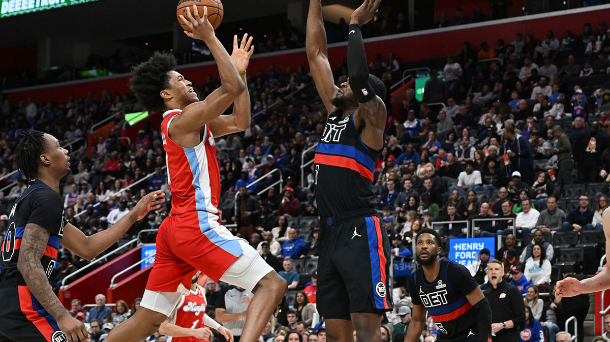 Memphis Grizzlies forward Jaylen Wells (0) drives to the basket against Detroit Pistons forward Paul Reed (7) in the fourth quarter at Little Caesars Arena. Mandatory Credit: Lon Horwedel-Imagn Images