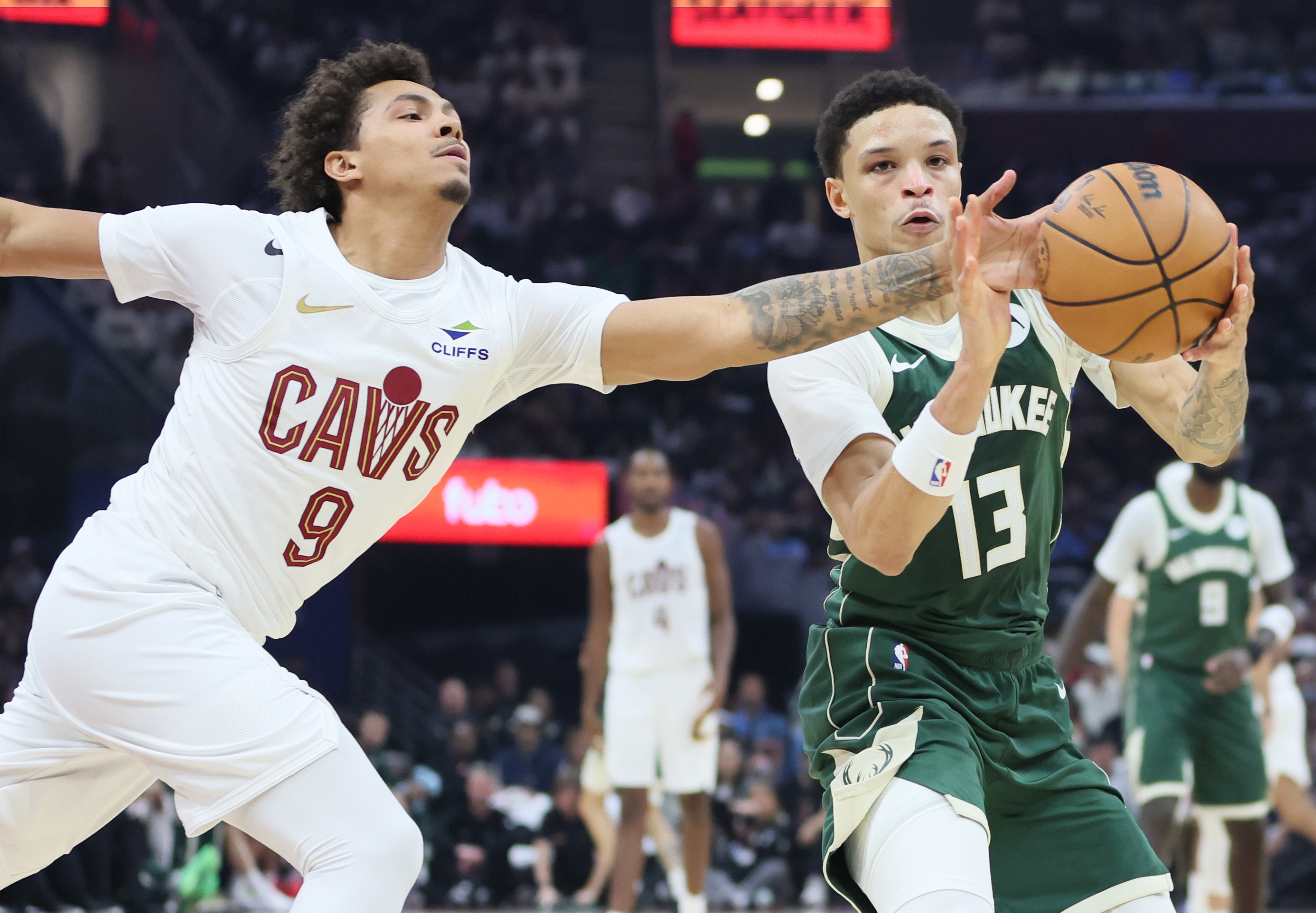 Cleveland Cavaliers guard Craig Porter Jr. reaches out to try and steal the pass to Milwaukee Bucks guard Ryan Rollins (R) in the first half at Rocket Arena. 