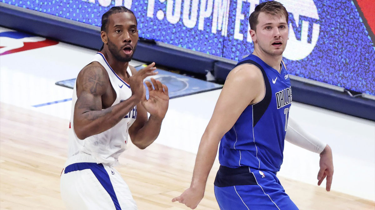 LA Clippers forward Kawhi Leonard (2) and Dallas Mavericks guard Luka Doncic (77) react after a Leonard shot during the fourth quarter during game six in the first round of the 2021 NBA Playoffs at American Airlines Center.