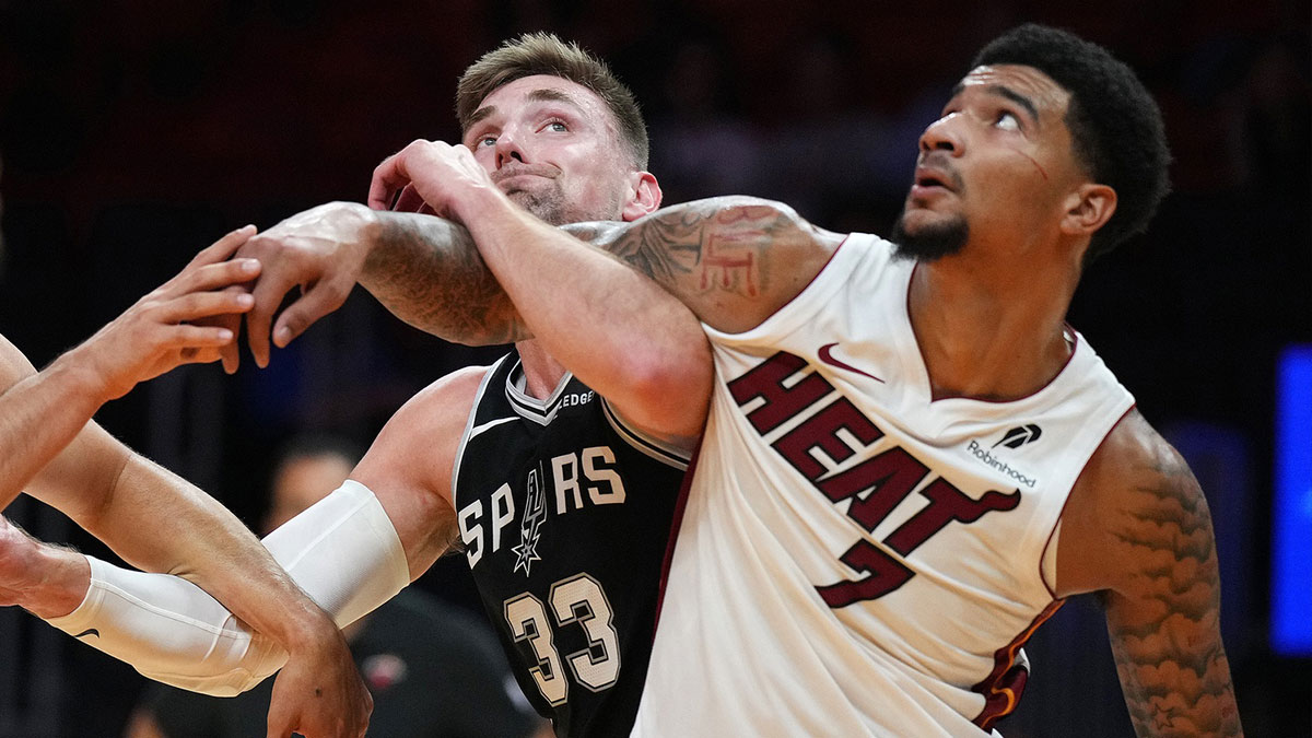 San Antonio Spurs center Micah Potter (33) battles for a rebound with Miami Heat center Kel'El Ware (7) during the second half at Kaseya Center.