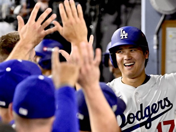 Shohei Ohtani #17 of the Los Angeles Dodgers high-fives teammates after hitting his third solo home run against the Milwaukee Brewers in the seventh inning of game 4 of a National League Championship Series baseball game at Dodger Stadium in Los Angeles on Friday, October 17, 2025. (Photo by Keith Birmingham, Pasadena Star-News/ SCNG)