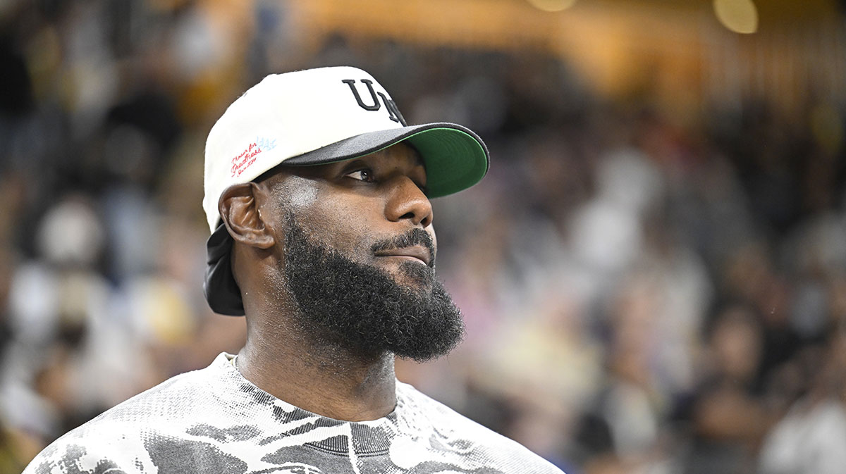 Lakers' Lebron James looks on during the first half against the Phoenix Suns at Acrisure Arena with Nick Wright in the background