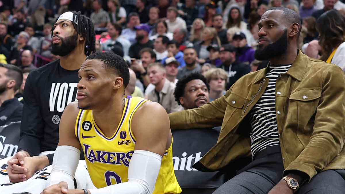 Lakers forward Anthony Davis (left) and guard Russell Westbrook (center) along with forward LeBron James (right) watch their team from the bench against the Utah Jazz in the fourth quarter at Vivint Arena