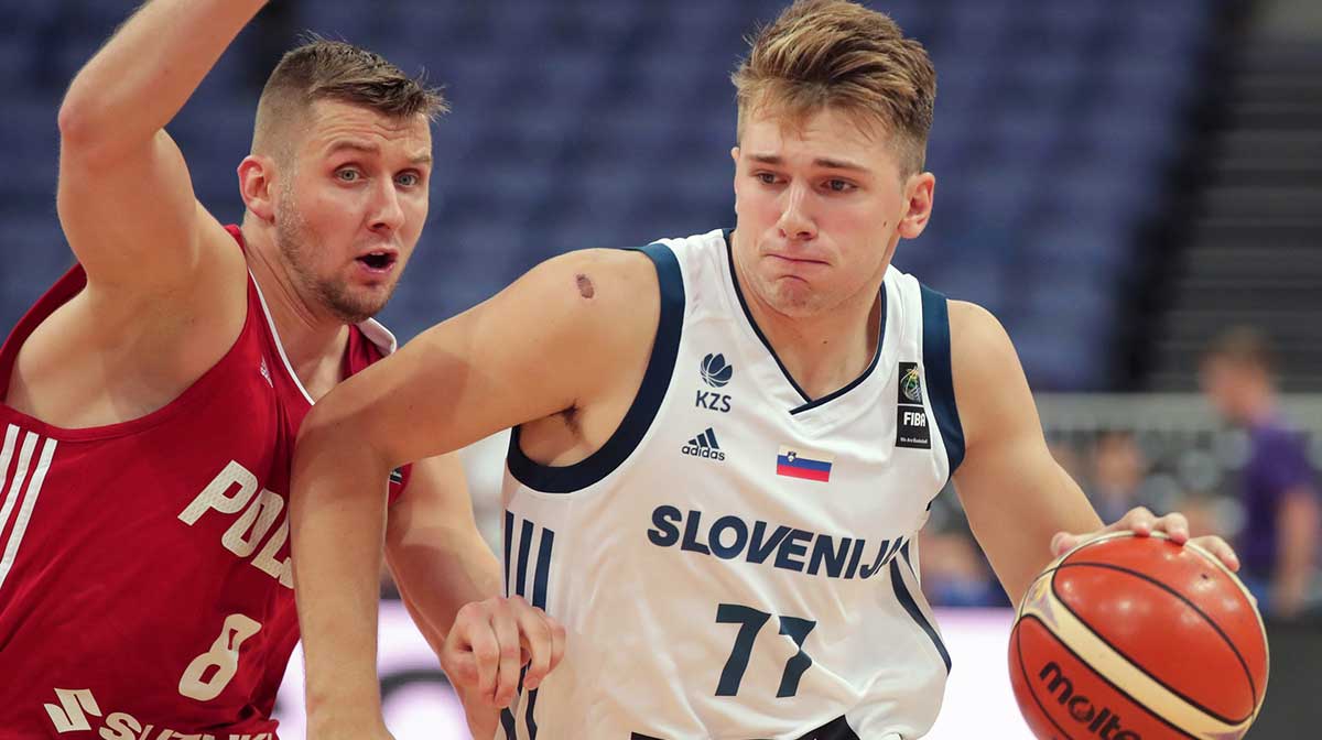Poland player Przemyslaw Zamojski (8) defends against Slovenia player Luka Doncic (77) during their FIBA Eurobasket Group A match in Helsinki Arena 31.